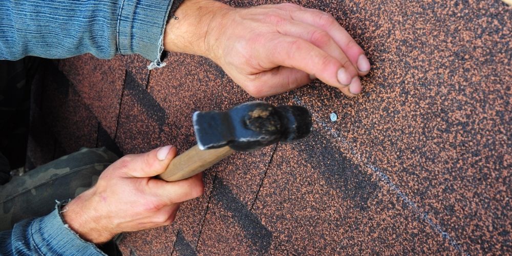 tools and elements to repair shingles on the roof