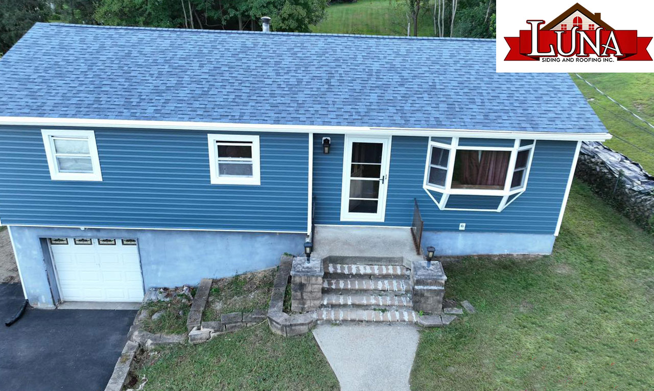 Professional siding installation in progress in New Hampton