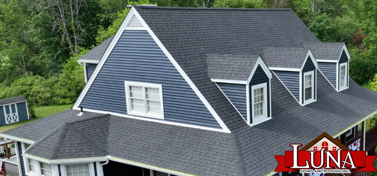 Best roofers in Kingston installing new shingles on a home